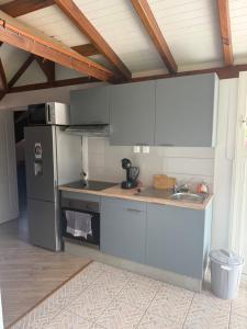 a kitchen with a sink and a refrigerator at Villa Lolyka in Terre-de-Haut