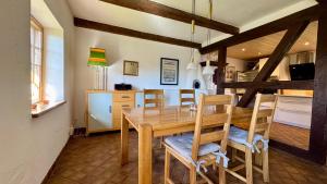 a kitchen and dining room with a wooden table and chairs at Alte Kate in Hobstin