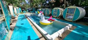 a pool with a toy duck in a swimming pool at Kulu Tubohostel Bacalar in Bacalar +3 photos