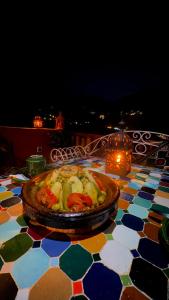 a table with a plate of food on a table at Atlas Walnut Hotel in Imlil