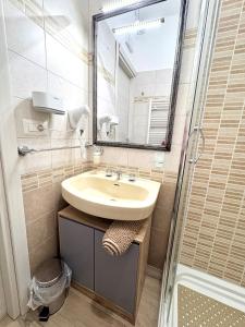 a bathroom with a sink and a shower at Stefy's House in Scalea +84 photos