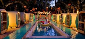 a water slide with a toy dog in a pool at Kulu Tubohostel Bacalar in Bacalar