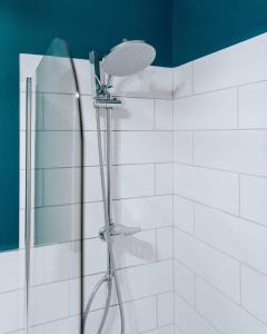 a shower with a shower head in a bathroom at Sandy Bay - Mins To Margate Main Sands in Margate