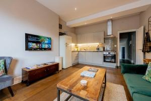 a living room with a couch and a table at Sandy Bay - Mins To Margate Main Sands in Margate