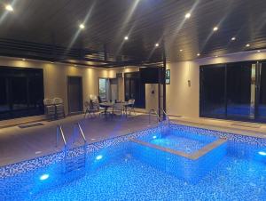 a swimming pool with a table and chairs and a table at Dareen Resort in Bahlāʼ +5 photos