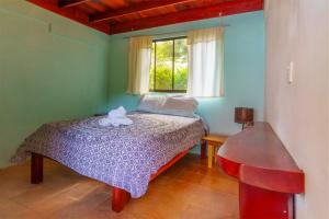 a bedroom with a bed in a room with a window at Jodokus Inn in Montezuma