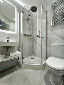 a bathroom with a shower and a toilet at NOX Chelsea in London +33 photos