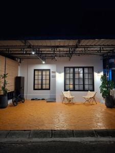 a large room with two white chairs in the middle at Enjoy and relax living villa style residence in Batam Center +22 photos