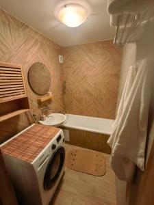 a bathroom with a sink and a washing machine at Zielony Balkon in Sanok