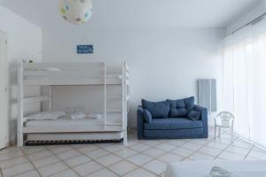 - une chambre avec des lits superposés et une chaise bleue dans l'établissement Lenerie - 800m plage - Wifi - Parking, à Préfailles