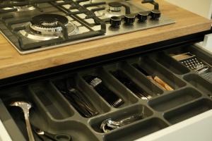a stove top oven with a drawer in a kitchen at Central City Vibes Apartment in Chişinău +18 photos