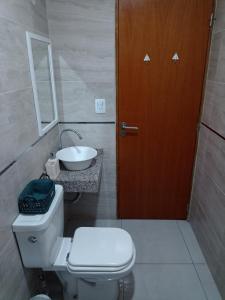 a bathroom with a toilet and a sink and a door at Monoambiente centrico in Santiago del Estero