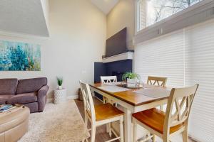 a dining room with a table and a couch at Trout Creek Condo Resort: Condo 78 in Conway