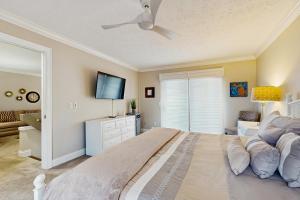 a bedroom with a large bed and a flat screen tv at Trout Creek Condo Resort: Condo 78 in Conway