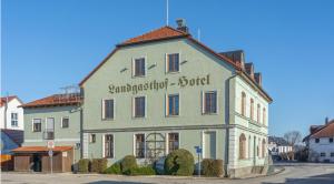 a building with a sign on the side of it at Hotel Forchhammer in Pliening