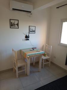 a table and two chairs in a room with a table at Monoambiente centrico in Santiago del Estero +2 photos