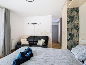 a bedroom with a large bed and a couch at Les Cerisiers in Saint-Étienne-de-Crossey +18 photos