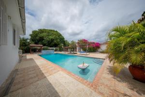 een zwembad met een boot in het midden bij Villa Laura, Central Spacious Oasis with Private Pool in Willemstad