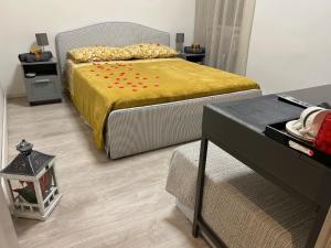 a bedroom with a large bed with a yellow bedspread at Vatican Stay Ottaviano in Rome +50 photos