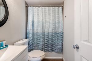a bathroom with a toilet and a shower curtain at Entire Home, 7 Minutes from Phoenix Airport in Phoenix +20 photos