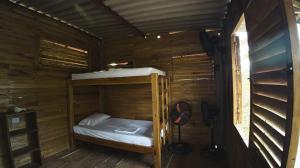 a small cabin with a bunk bed in it at Hotel Paradise in Isla Fuerte