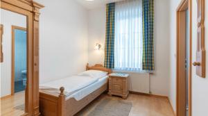 a small bedroom with a bed and a window at Hotel Forchhammer in Pliening