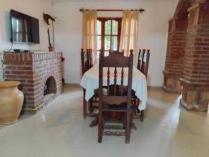 a living room with a table and a fireplace at Alquiler Temporal Ñuca huasi in Salta