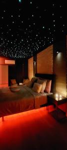 a large bedroom with a large bed and a table at Pause Thermale Chambre avec Spa in Herstal