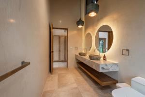 a bathroom with a sink and a mirror at Villa Bahia Oceanview Designer Retreat Malpais in Mal País +39 photos