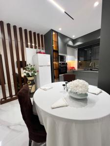 a table with a white table cloth on it in a kitchen at maisoncarnot in El Biar