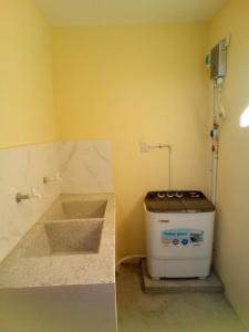 a small kitchen with a sink and a stove at Mi Refugio in San Fernando de Monte Cristi +23 photos