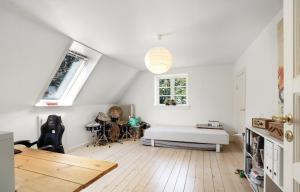 ein weißes Zimmer mit einem Bett und einem Tisch in der Unterkunft Large Holiday Home With Pool On South Lolland Coast in Dannemare + 24 Fotos