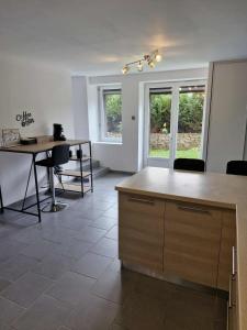 a kitchen with a table and chairs in a room at Au Clerc de Lune in Broye +12 photos