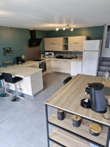 a kitchen with white cabinets and a table and chairs at Au Clerc de Lune in Broye