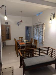 a dining room with a table and chairs at Sankeerthanam - Lounge in serenity in Cochin +32 photos