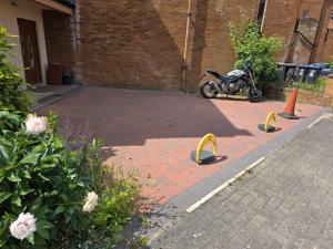 a motorcycle parked in a parking lot with barriers at Wembley Park prime location for Stadium events City break in London