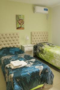 Giường trong phòng chung tại Quiya ná