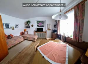 a living room with a couch and a bed at Appartement Schuller in Wagrain