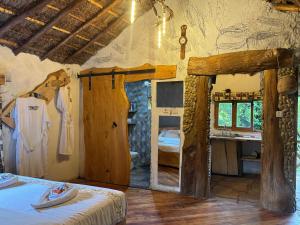 a room with a bedroom with a bed and a bathroom at Podocarpus cottages in Naro Moru