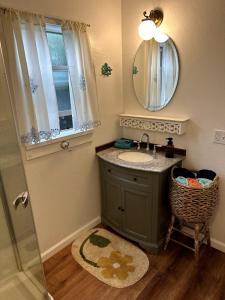 a bathroom with a sink and a mirror and a shower at Sal's Beach Cottage Retreat in Fort Bragg +49 photos