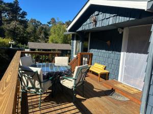 a patio with a table and chairs on a deck at Sal's Beach Cottage Retreat in Fort Bragg
