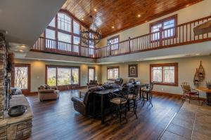 a large living room with a table and chairs at Sunnyside Farm in Boone