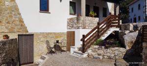 a house with a staircase and a table on a patio at Casa da Pedra - Alvados, Porto de Mós in Alvados +12 photos