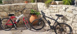 two bikes parked next to a stone wall at Casa da Pedra - Alvados, Porto de Mós in Alvados