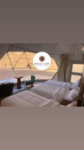 a group of beds in a tent with a view at Royal camp in Wadi Rum