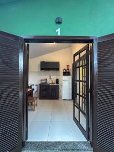 an open door leading to a kitchen with a kitchenasteryasteryasteryasteryasteryastery at Verde Mar Ilha Grande in Abraão +13 photos