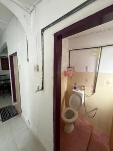 a bathroom with a toilet in a room at YDK Homestay in Padang Rengas