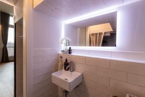 a bathroom with a sink and a mirror at Loft - Zur alten Schule in Essingen in Essingen +31 photos