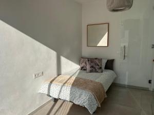 a bedroom with a bed in a white room at Fabulous 2 bed-townhouse with large rooftop! in Estepona