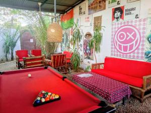 a billiard room with a red pool table at La CASA - Guesthouse in Ouagadougou